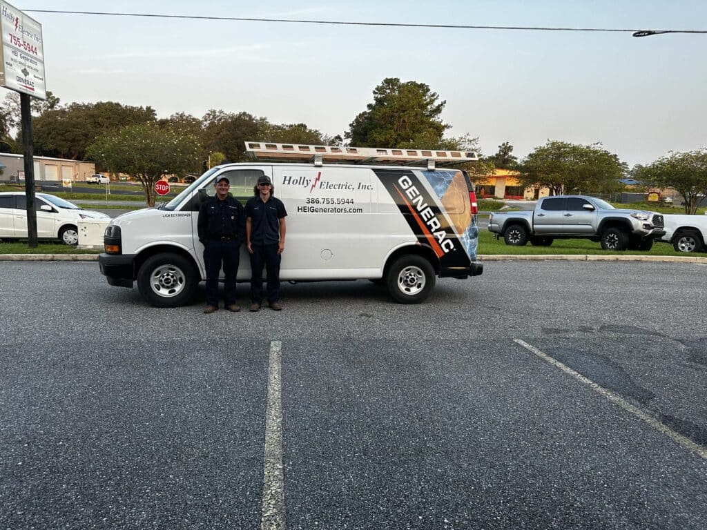 Two Holly Electric technicians standing beside the company generator service van in Lake City, FL