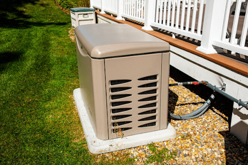 Whole-house standby generator installed on a concrete pad beside a home